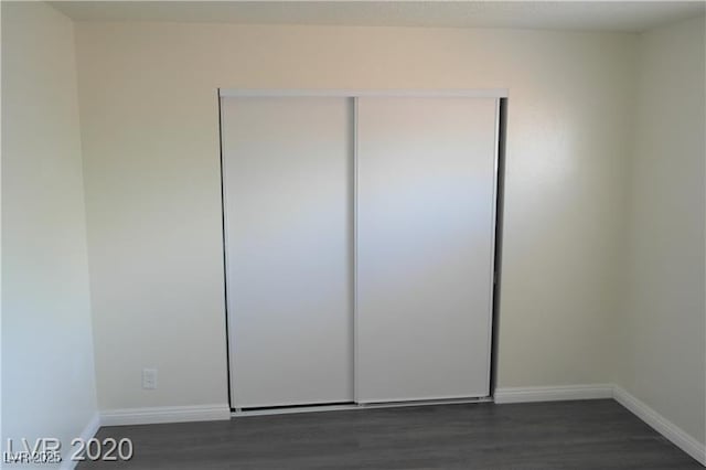 unfurnished bedroom featuring dark hardwood / wood-style floors