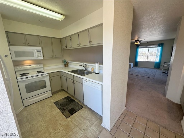 kitchen with ceiling fan, sink, white appliances, a textured ceiling, and light carpet