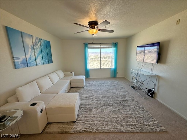 living room featuring ceiling fan, light carpet, and a textured ceiling