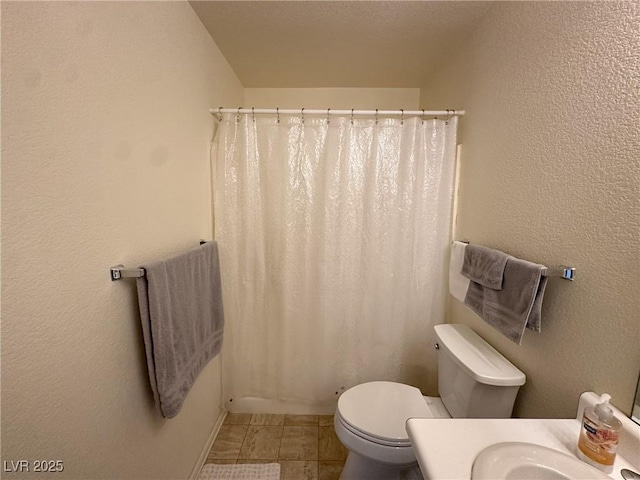 bathroom with toilet and a shower with shower curtain