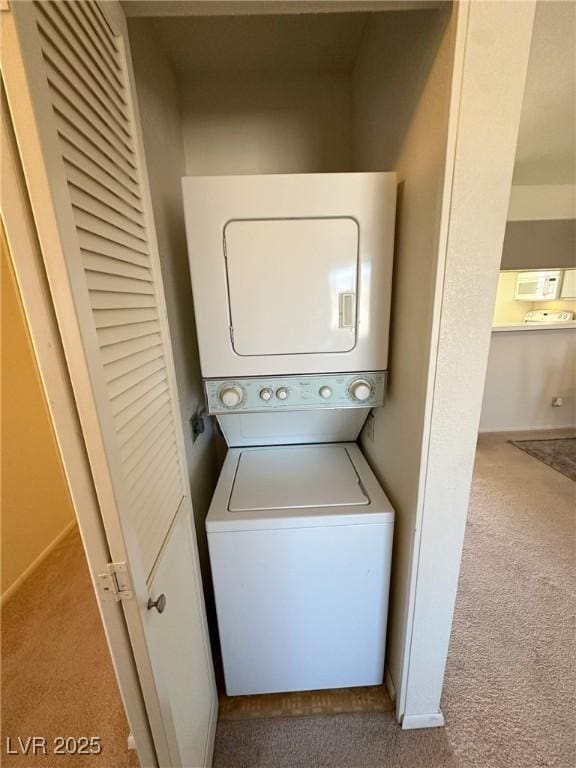 washroom with light carpet and stacked washing maching and dryer