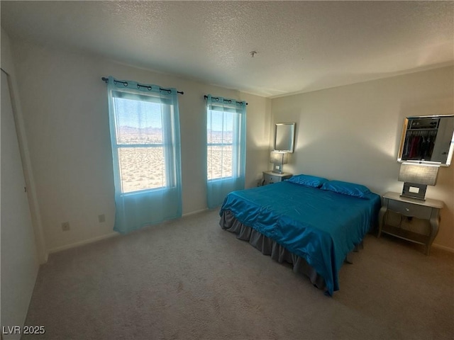 carpeted bedroom featuring a textured ceiling