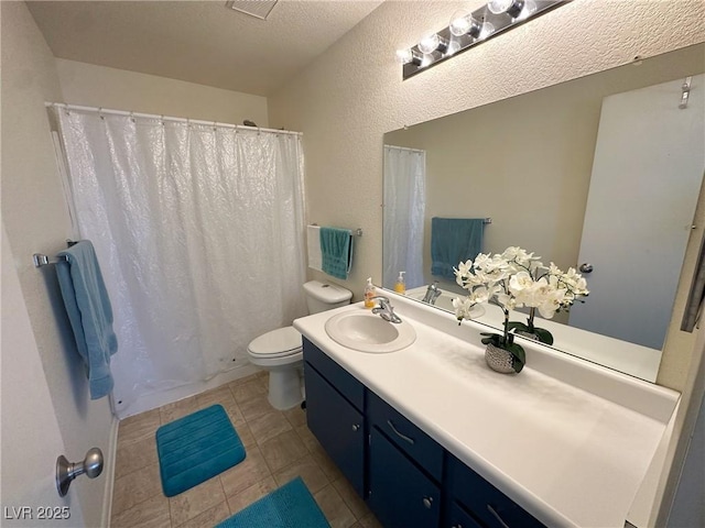 bathroom featuring toilet, tile patterned flooring, a textured ceiling, and vanity