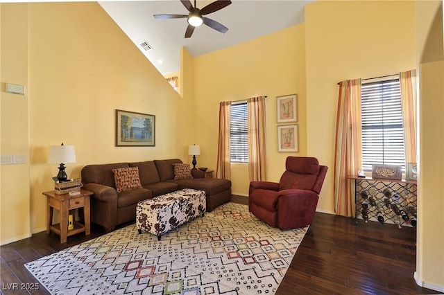 living room featuring ceiling fan, hardwood / wood-style flooring, and high vaulted ceiling