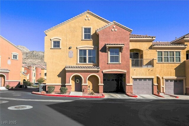 view of front facade with a mountain view and a garage