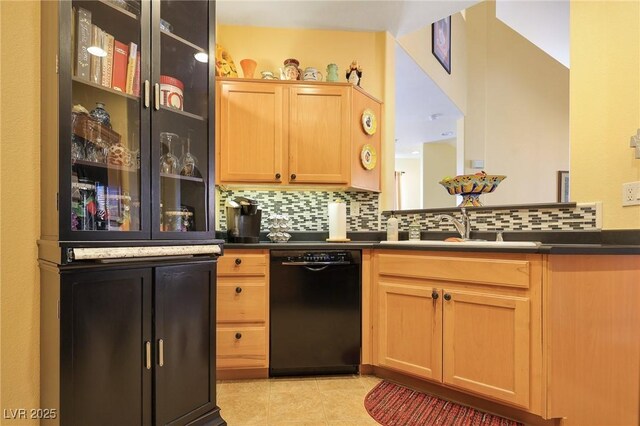 kitchen featuring sink, light brown cabinets, black dishwasher, and tasteful backsplash