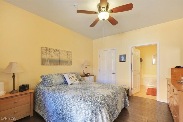 bedroom featuring ceiling fan, hardwood / wood-style floors, and ensuite bath