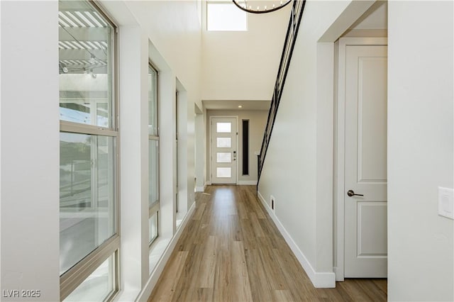 hall featuring plenty of natural light and light wood-type flooring