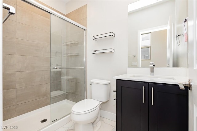 bathroom featuring walk in shower, vanity, and toilet