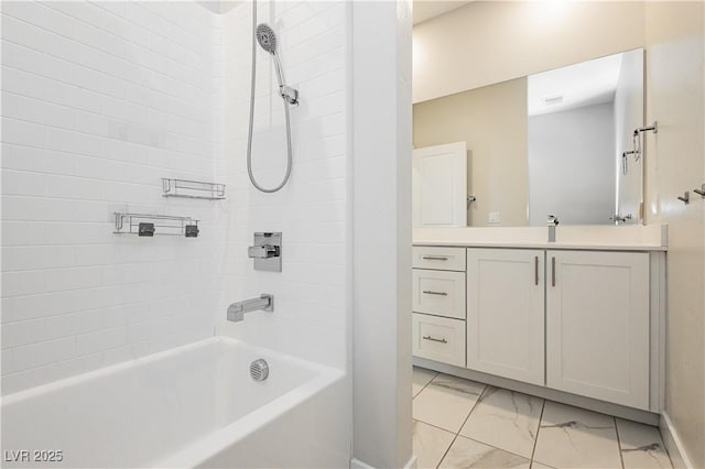 bathroom with vanity and tiled shower / bath