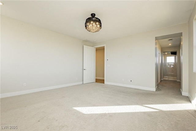 unfurnished room with light colored carpet