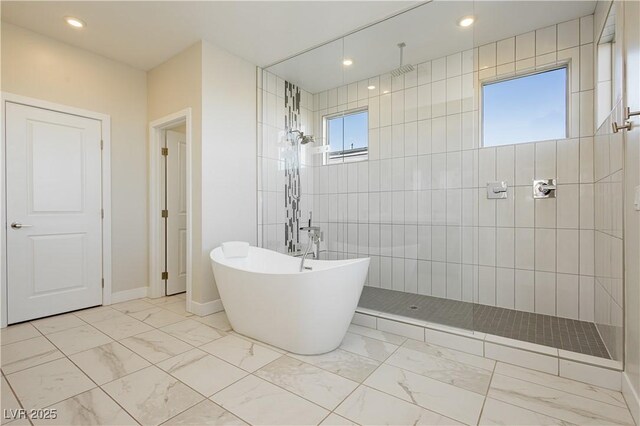 bathroom featuring shower with separate bathtub