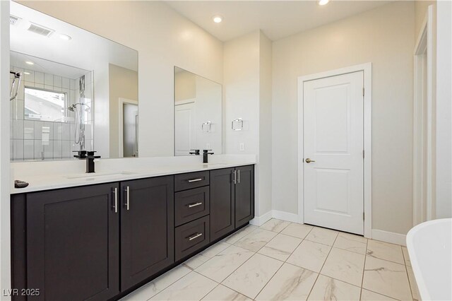 bathroom with vanity and a tile shower