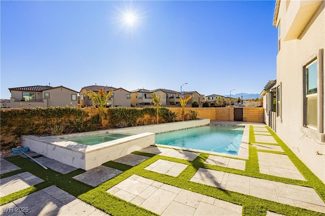 view of swimming pool with a patio and an in ground hot tub