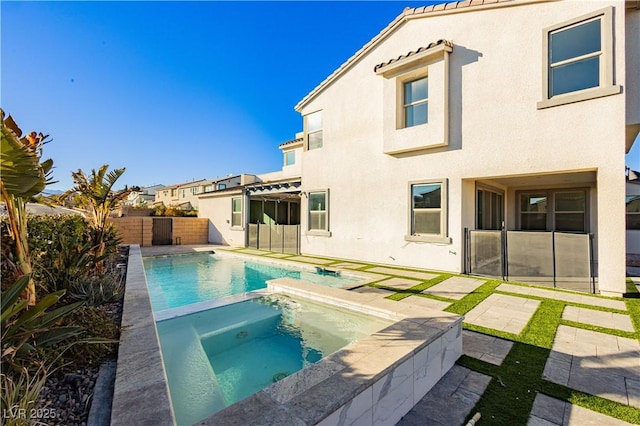 view of pool with a patio area and an in ground hot tub