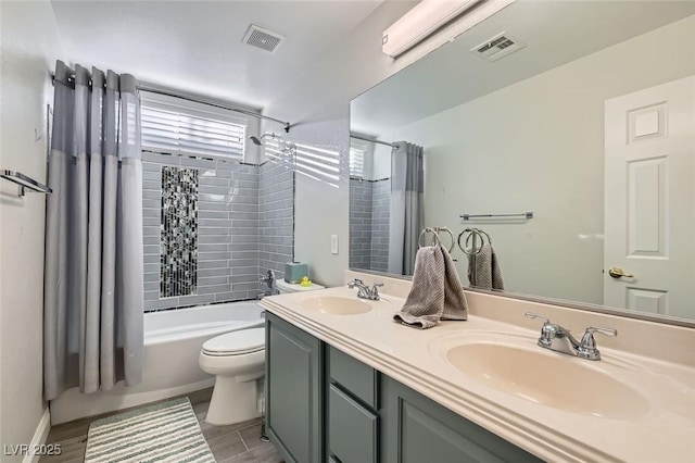 full bathroom with toilet, shower / bathtub combination with curtain, and vanity