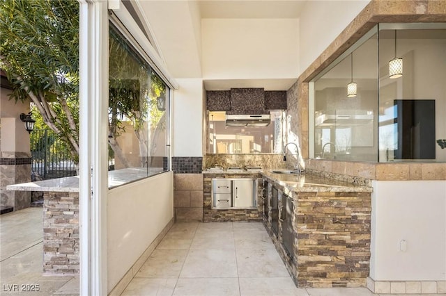 view of patio featuring exterior kitchen and sink