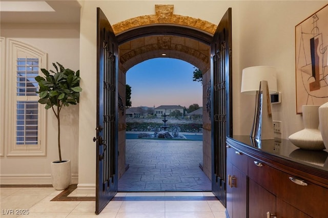 doorway to outside featuring light tile patterned flooring