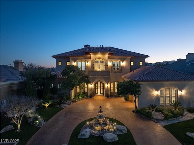 mediterranean / spanish-style house with french doors