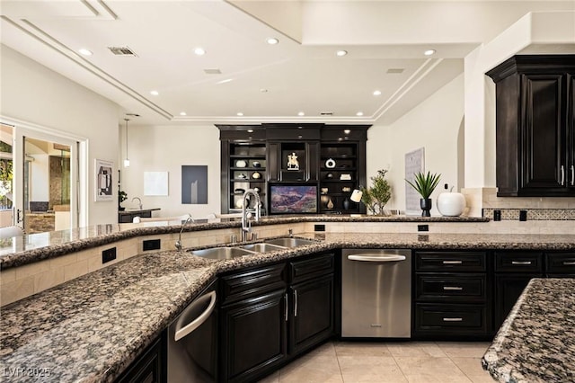 kitchen featuring light tile patterned floors, dishwasher, sink, and dark stone countertops