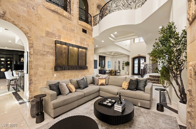 living room featuring a towering ceiling and french doors