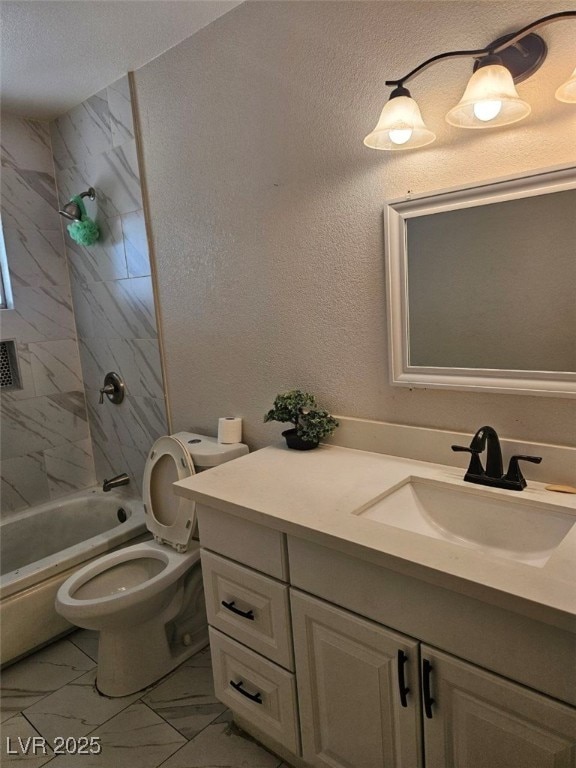 full bathroom featuring tiled shower / bath combo, vanity, and toilet