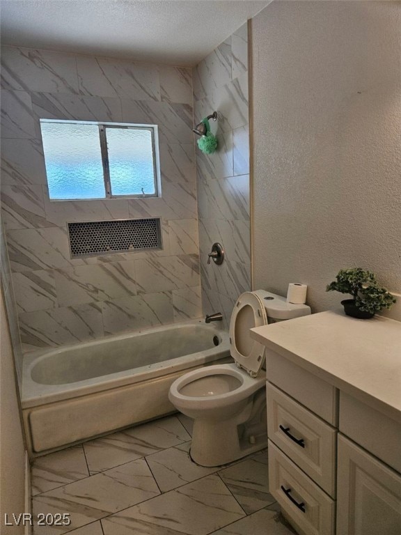 full bathroom with tiled shower / bath combo, toilet, and vanity