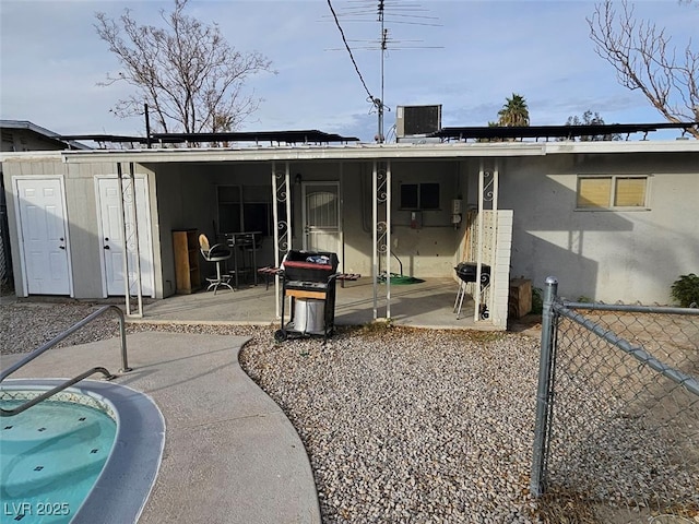 back of property featuring central AC unit and a patio