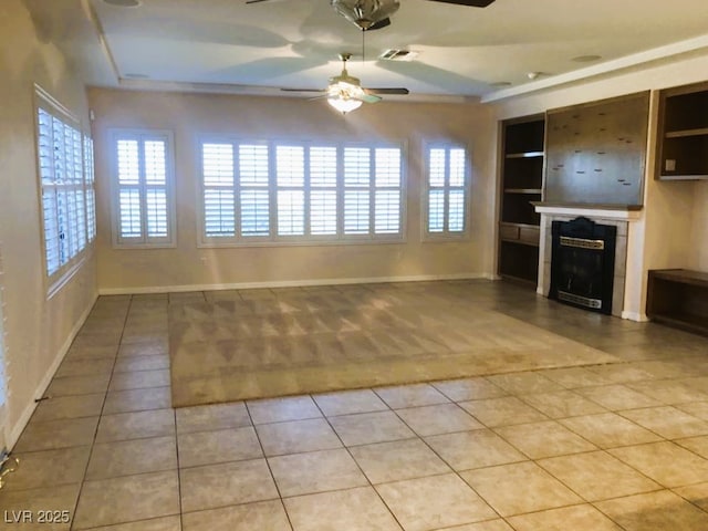 unfurnished living room featuring ceiling fan, light tile patterned floors, and built in features