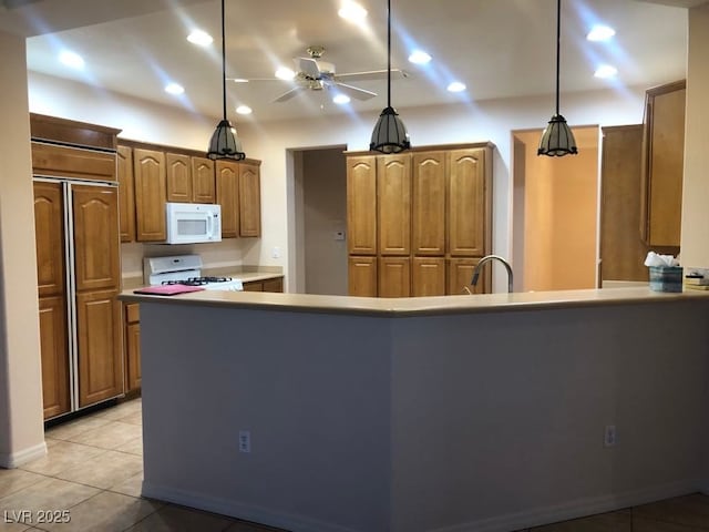 kitchen with light tile patterned floors, ceiling fan, decorative light fixtures, white appliances, and sink