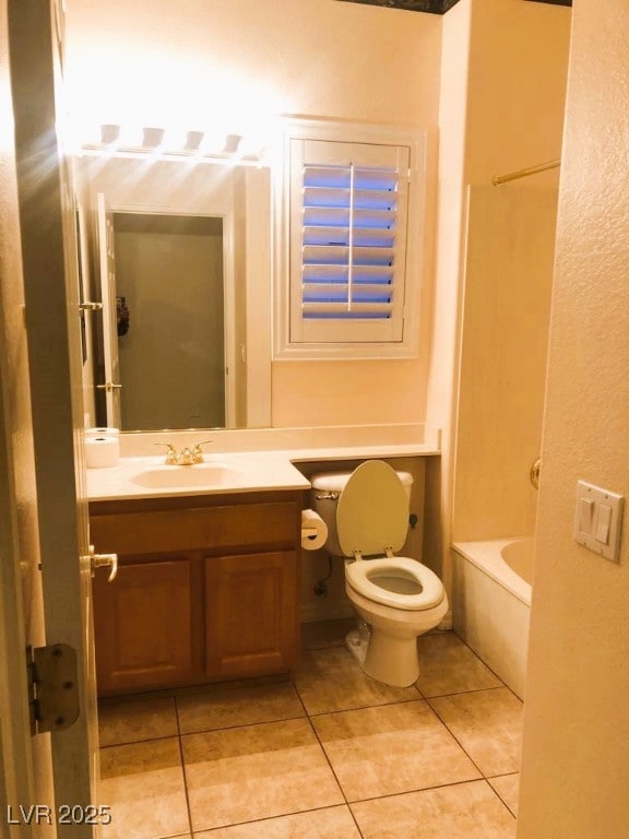 bathroom with toilet, vanity, tile patterned flooring, and a washtub