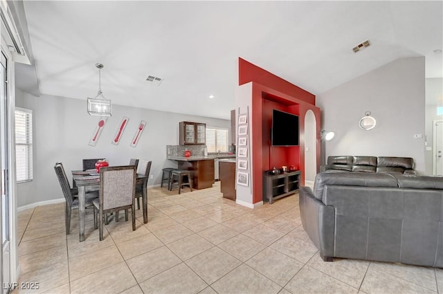 living room featuring light tile patterned floors and a healthy amount of sunlight