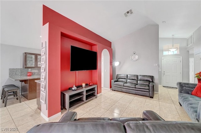 tiled living room with lofted ceiling