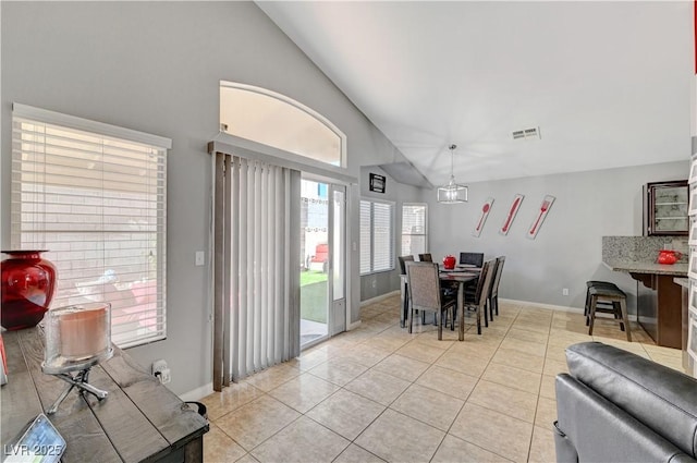 tiled dining area featuring lofted ceiling