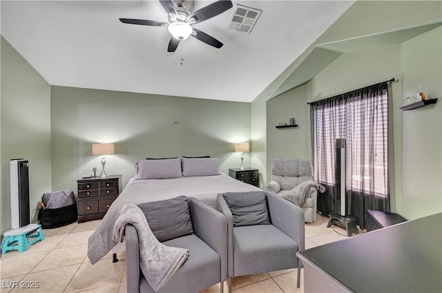 bedroom with ceiling fan, vaulted ceiling, and light tile patterned flooring