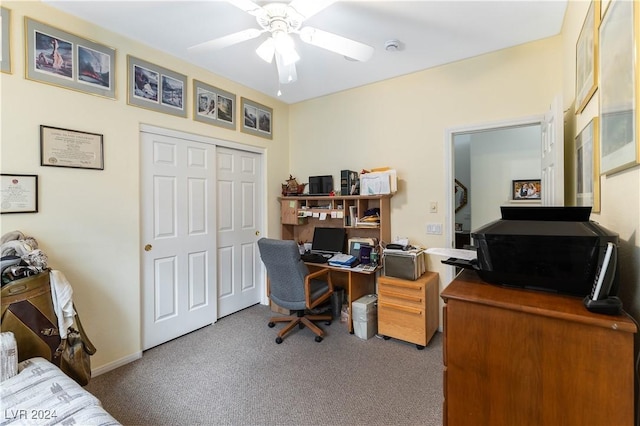 carpeted office featuring ceiling fan