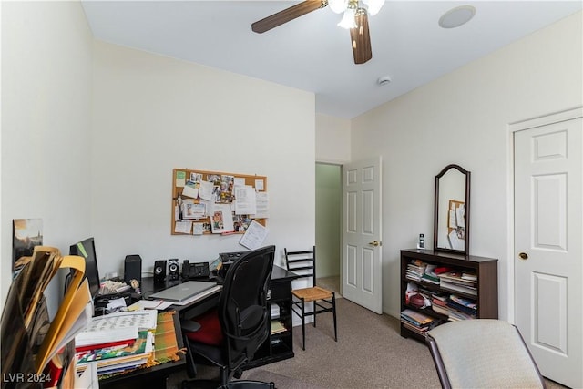 carpeted office space featuring ceiling fan