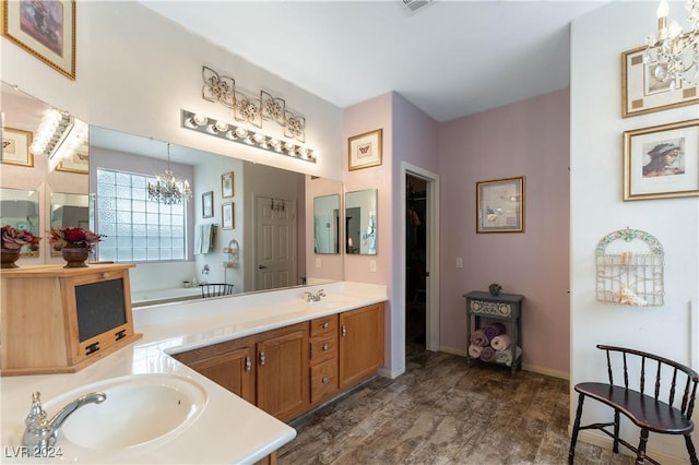 bathroom featuring vanity, an inviting chandelier, and hardwood / wood-style floors