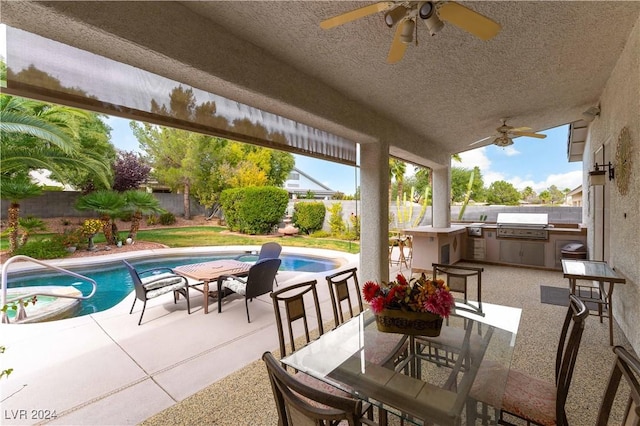 view of patio with ceiling fan, exterior kitchen, a fenced in pool, and area for grilling