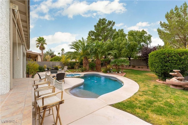 view of pool featuring a patio area and a lawn