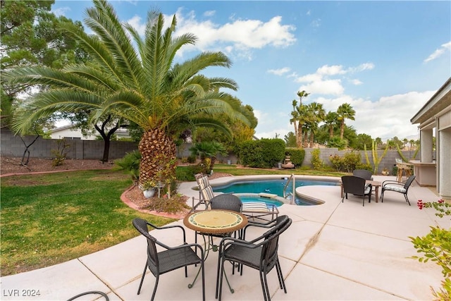 view of pool with a lawn and a patio