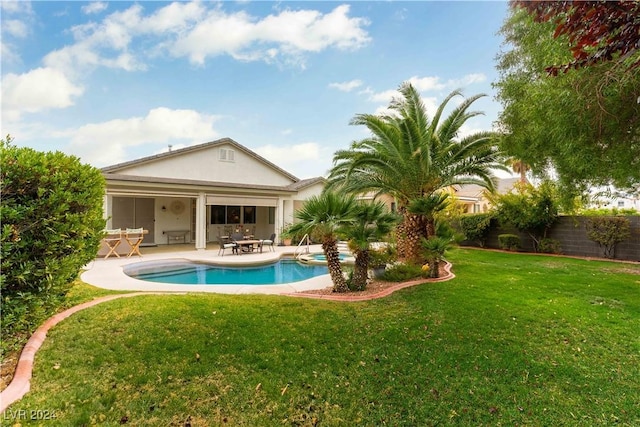 view of pool featuring a patio area and a lawn