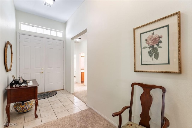 view of carpeted foyer entrance