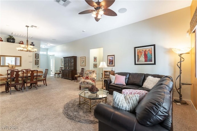 living room with ceiling fan with notable chandelier and carpet