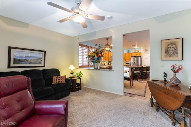 living room with ceiling fan and carpet flooring