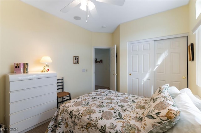 carpeted bedroom featuring ceiling fan and a closet