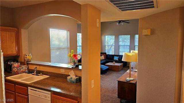 kitchen with carpet floors, dishwasher, sink, and ceiling fan