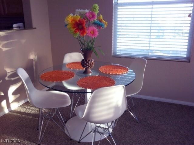 carpeted dining room featuring a wealth of natural light