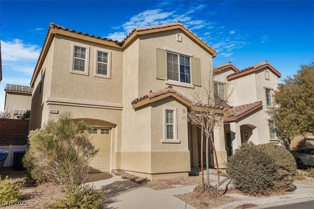 mediterranean / spanish-style house with a garage