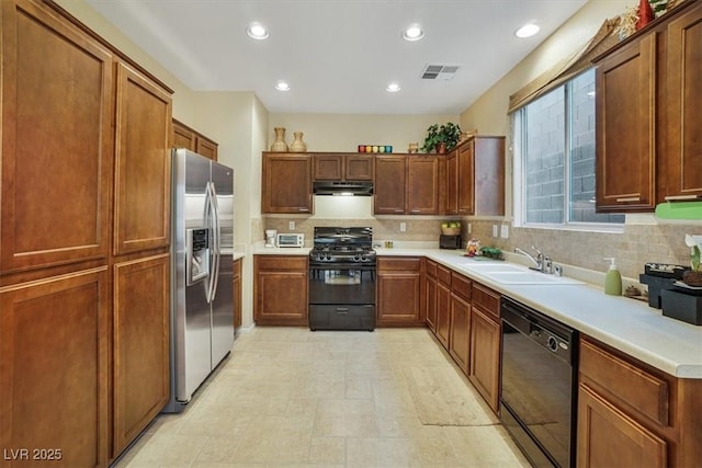 kitchen with tasteful backsplash, sink, and black appliances